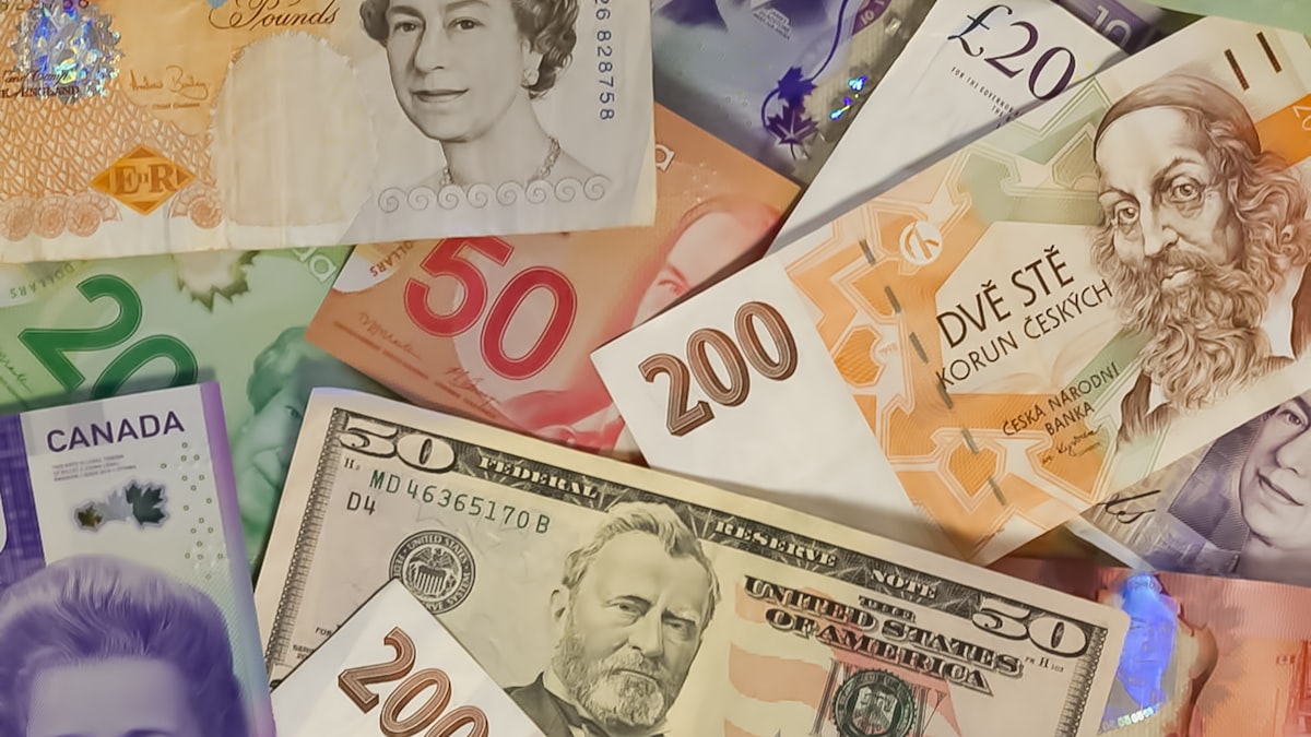 The Big Week Ahead: JPY, EUR, USD and GBP — A collection of international banknotes including US dollars, British pounds, and Czech koruna
