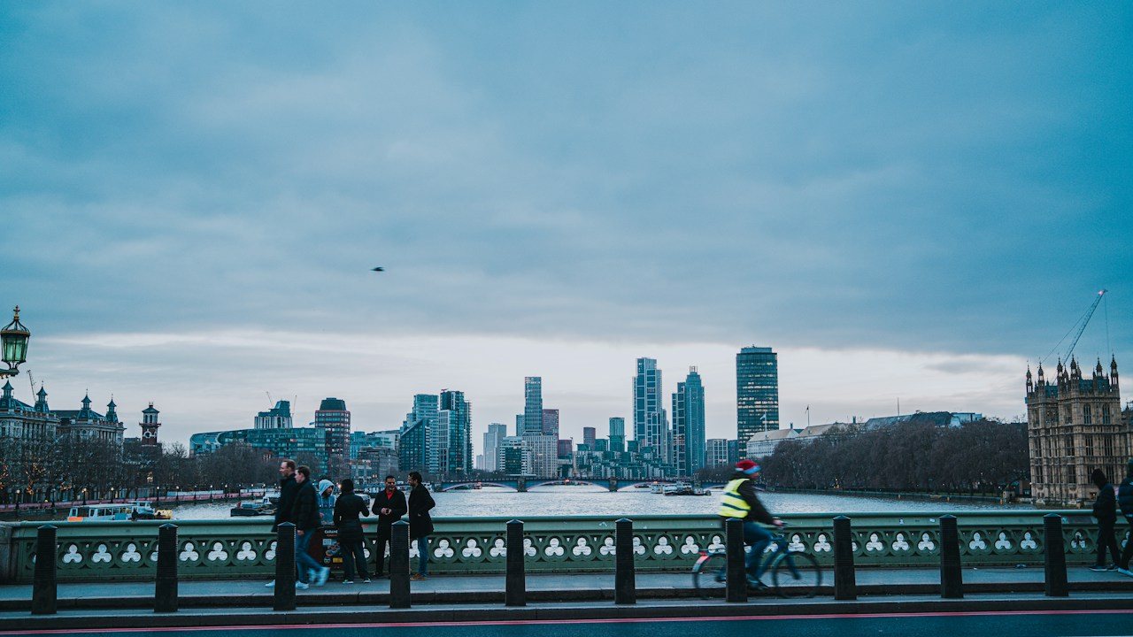 Commuters crossing a London bridge early in the morning as the forex trading day begins in the UK