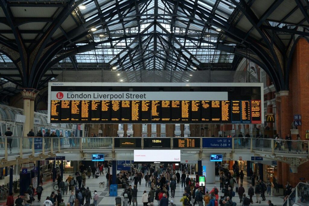 Commuters reading a railway departure board, like a market order that fills at the price showing now