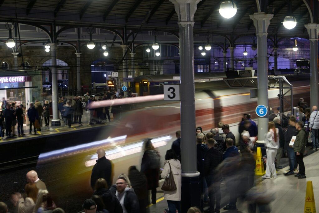 Crowded station concourse at rush hour, like volume clustering at a price while time spreads elsewhere