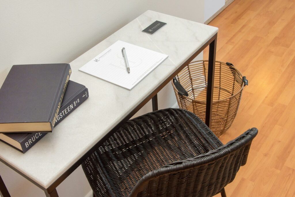 Notebooks and a pen on a small desk, used to work out a smaller position size before a release