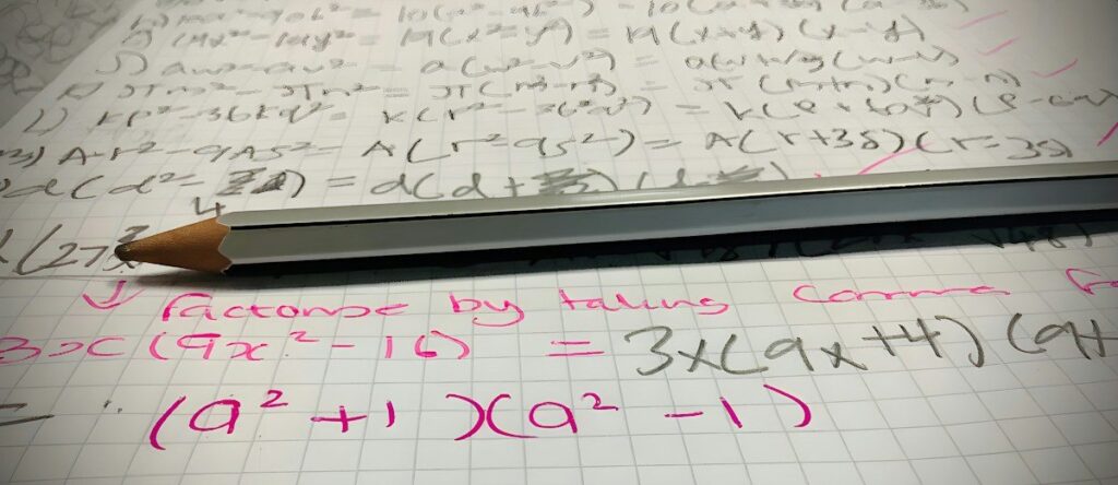 Pencil on grid paper covered in handwritten algebra, working out the odds of ruin