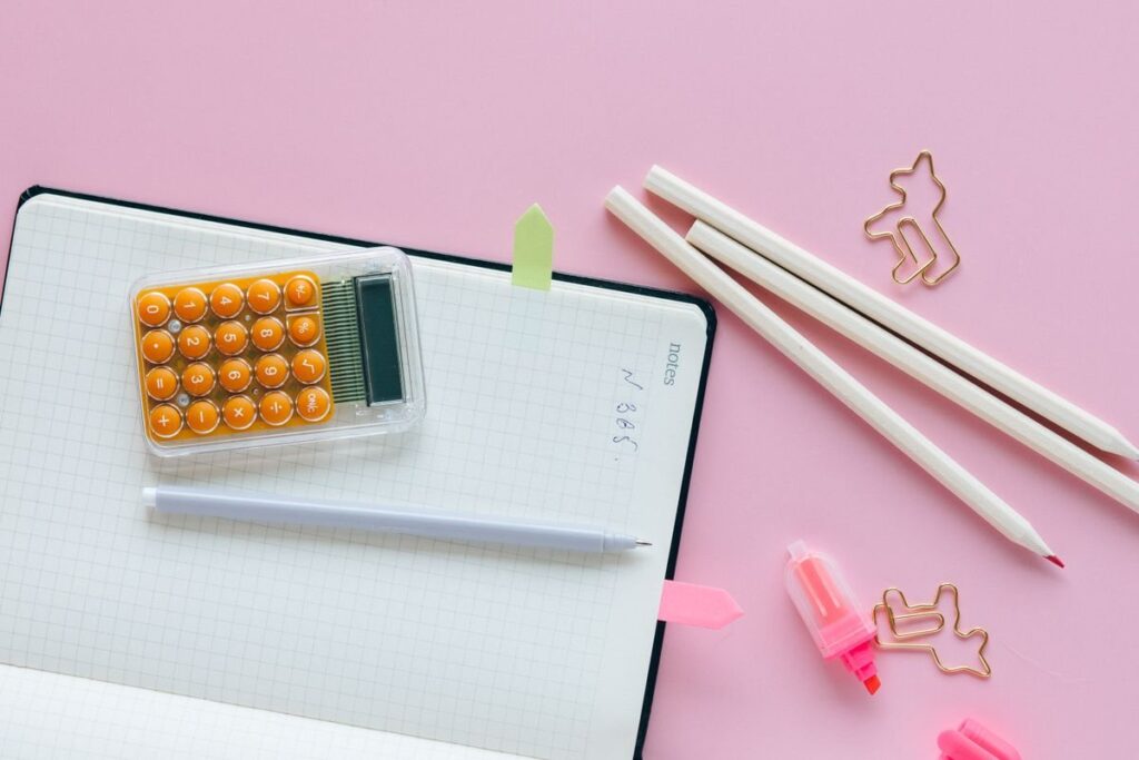 Calculator and pencil on squared paper, used to count profile rows and work out the 70% value area