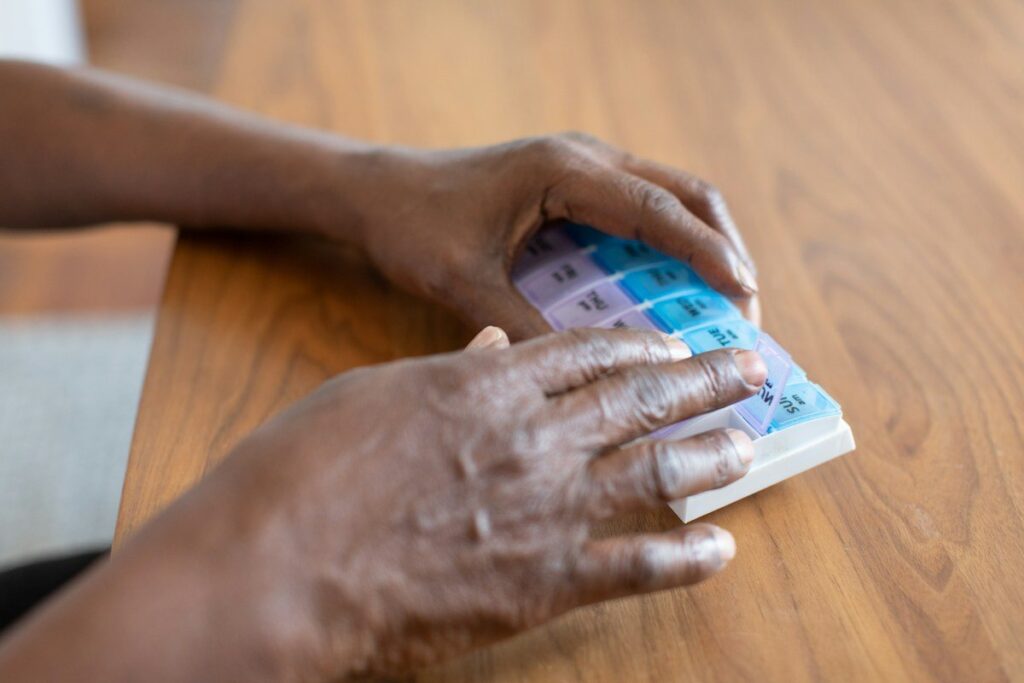 Hand on a small calculator on a wooden table, checking the figures for a partial take-profit plan