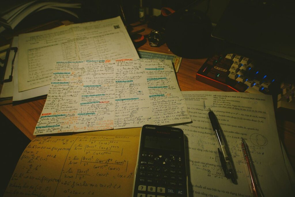 Calculator and pen on handwritten notes