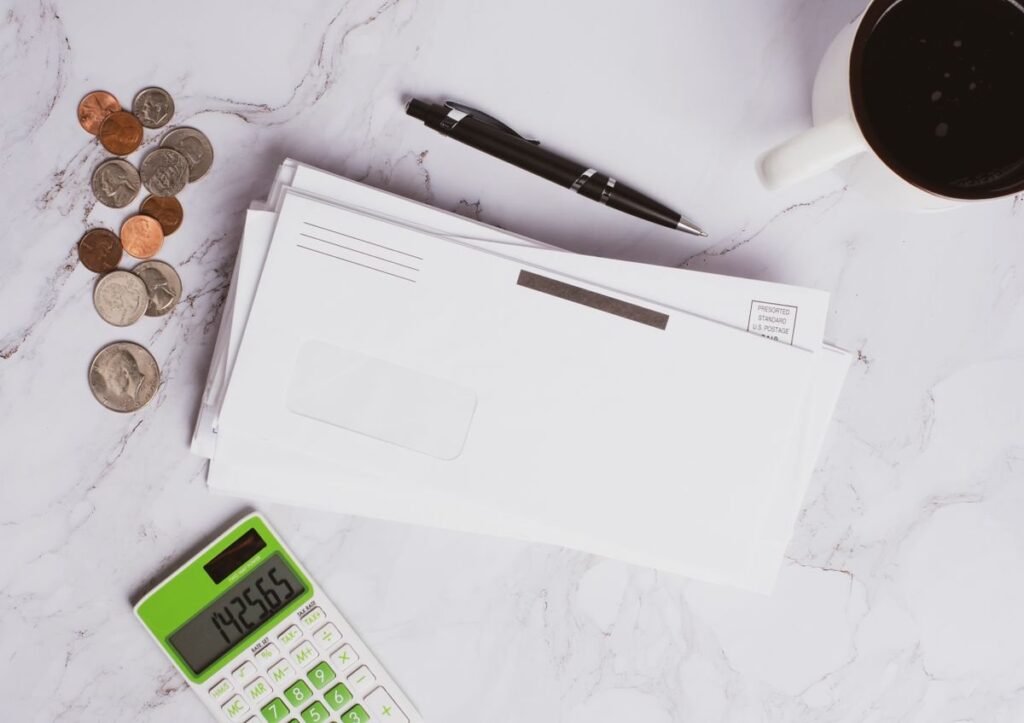 Calculator beside a coffee mug, used to size a Bitcoin position for a wide crypto stop