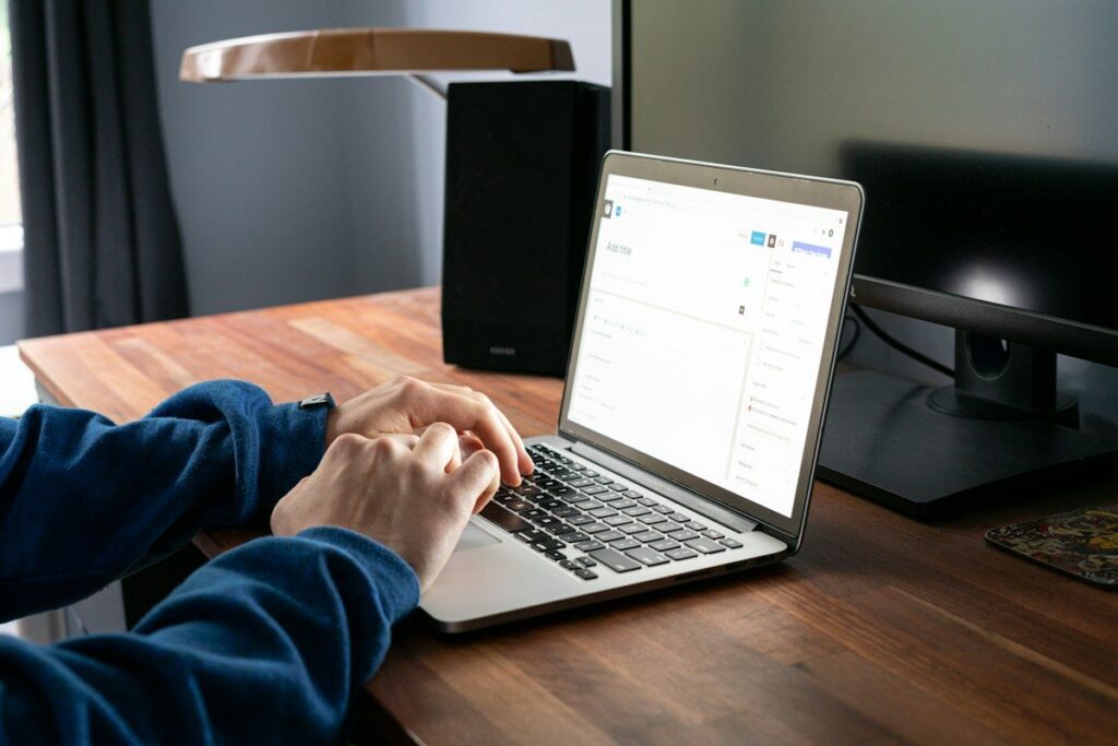 Laptop on a wooden desk in daylight, ready for reading a clean price action chart