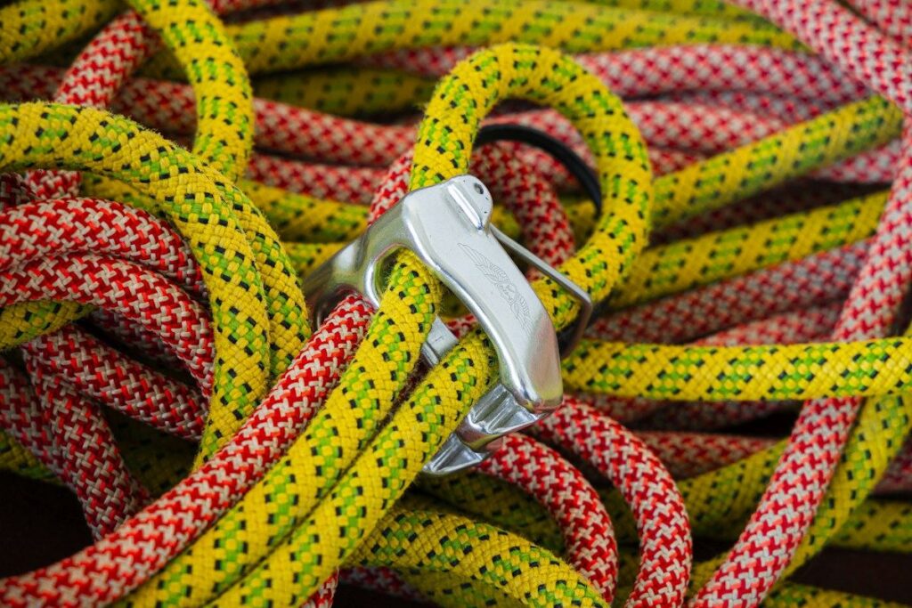 Climbing rope clipped into a carabiner, a picture of a stop loss order protecting an open trade