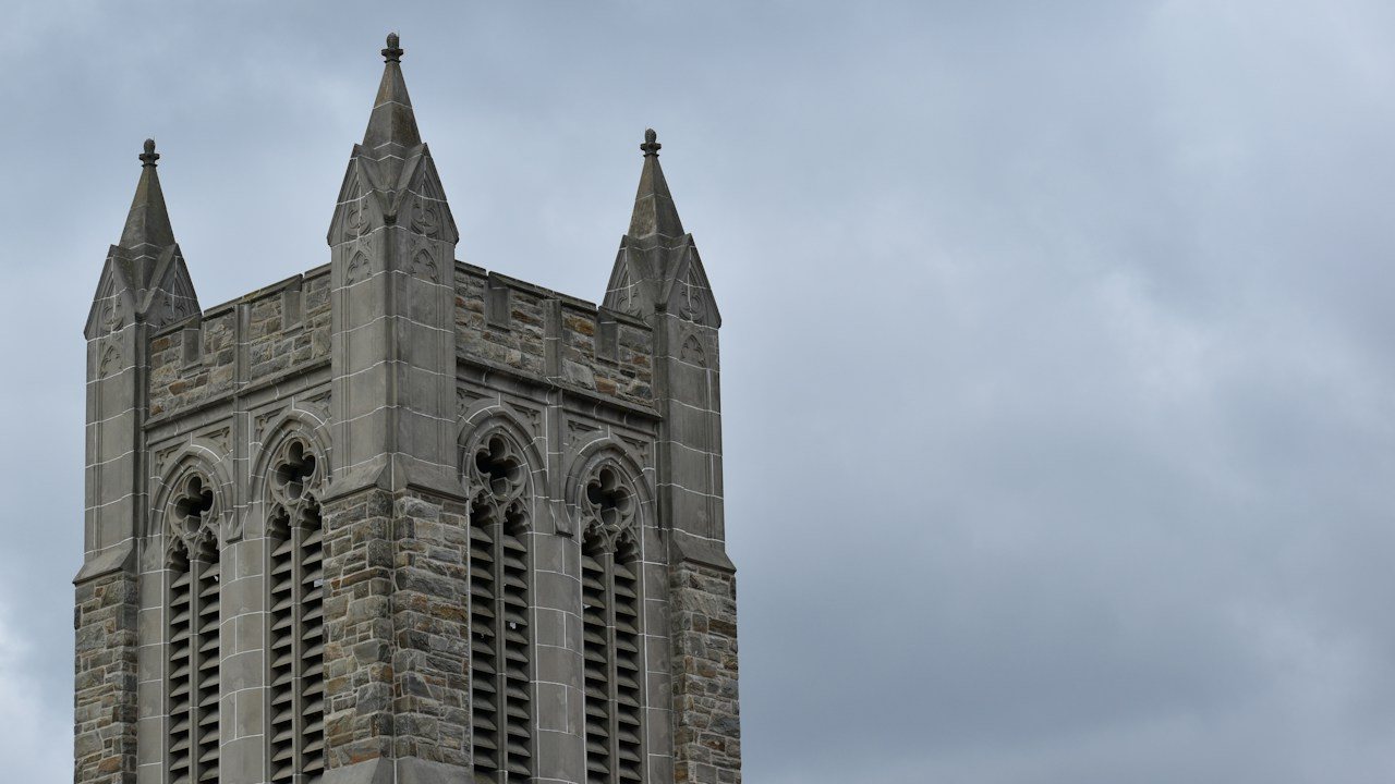 Church tower with twin spires against a grey sky, like the twin peaks of a double top pattern