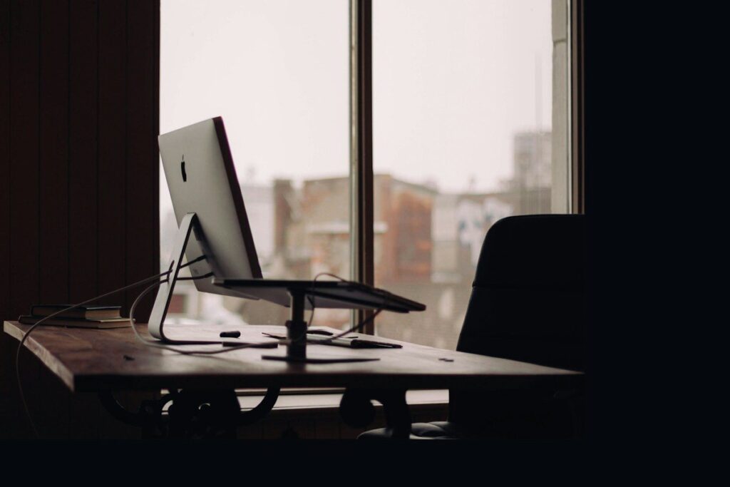 Empty office chair at a desk by a window, a reminder to step away instead of chasing a loss
