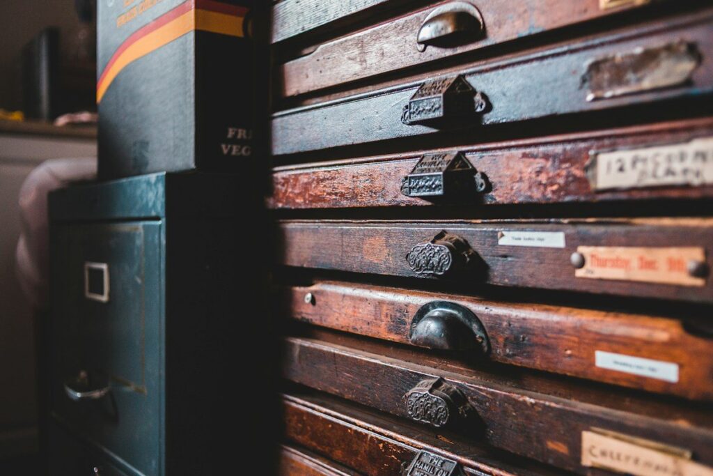 Old wooden filing drawers with labels, a reminder to check how spread betting tax applies to you