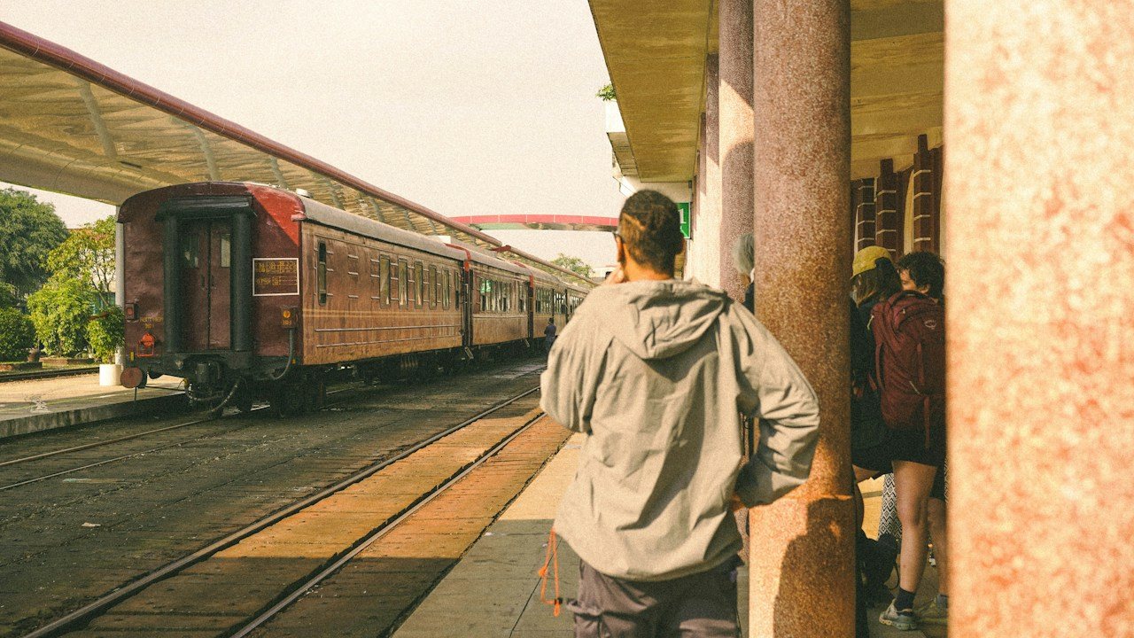 Man on a platform watching a train leave, like FOMO in trading when a move runs without you
