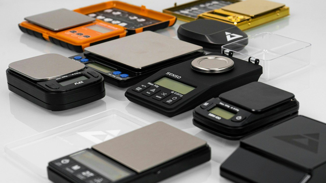 Digital pocket scales in rows on a white surface, a picture of weighing gold supply and demand zones