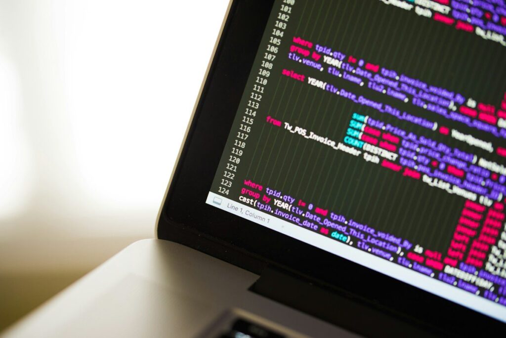 Laptop screen showing lines of code, the kind of script that logs each backtest trade with its entry, stop and result