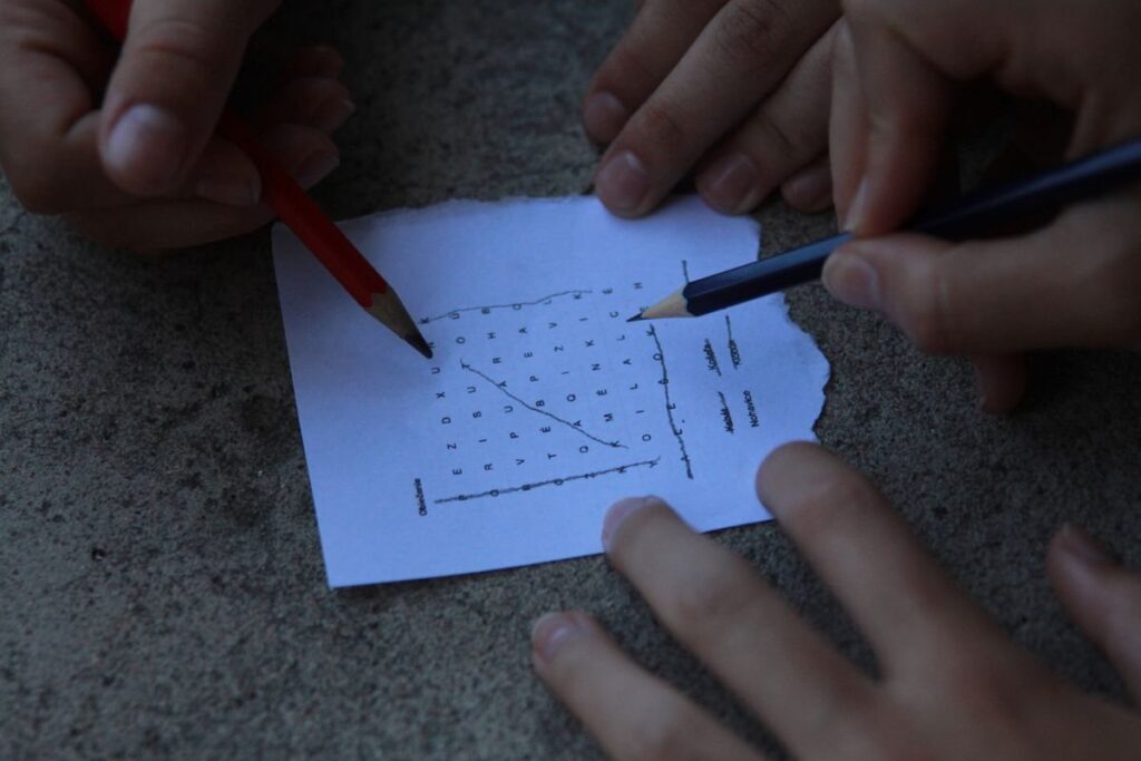 Hand sketching TPO letters on graph paper to show how to read a market profile chart