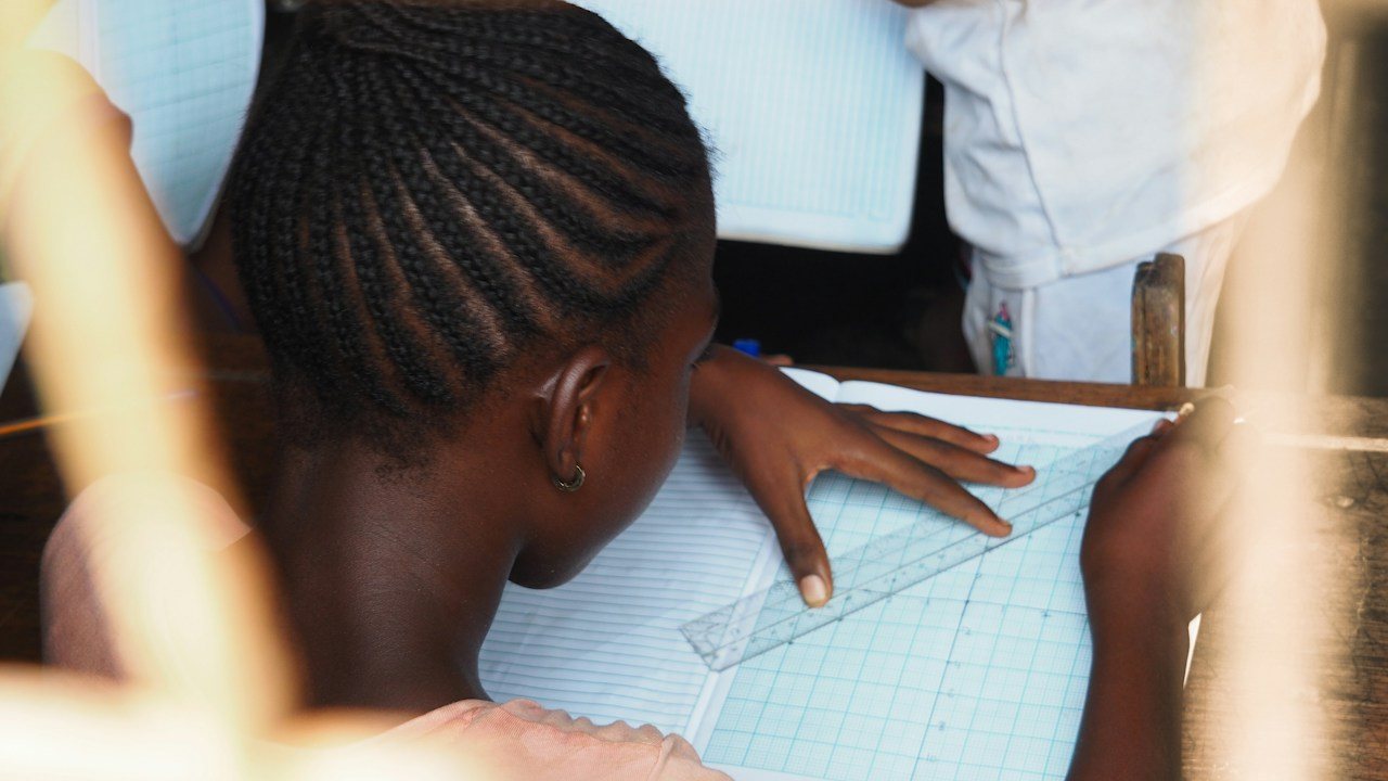 Student using a ruler on graph paper, measuring each step as carefully as a backtest of past price data