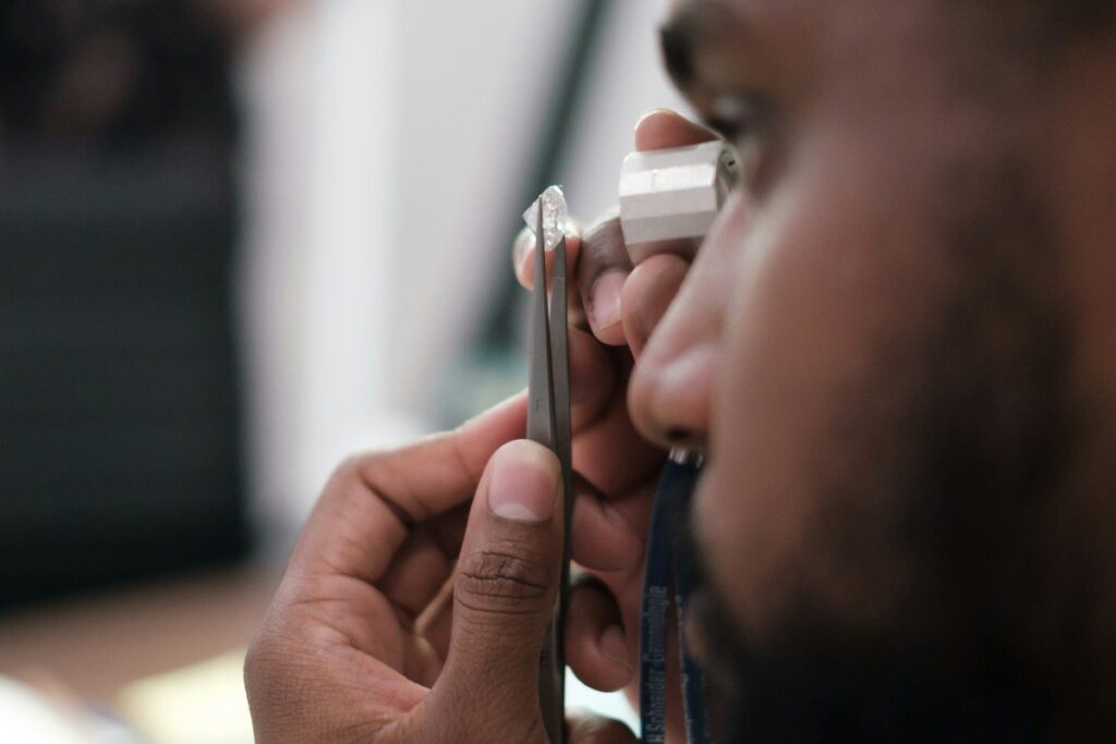Jeweller inspecting a ring through a loupe, the close look needed before trusting a gold zone