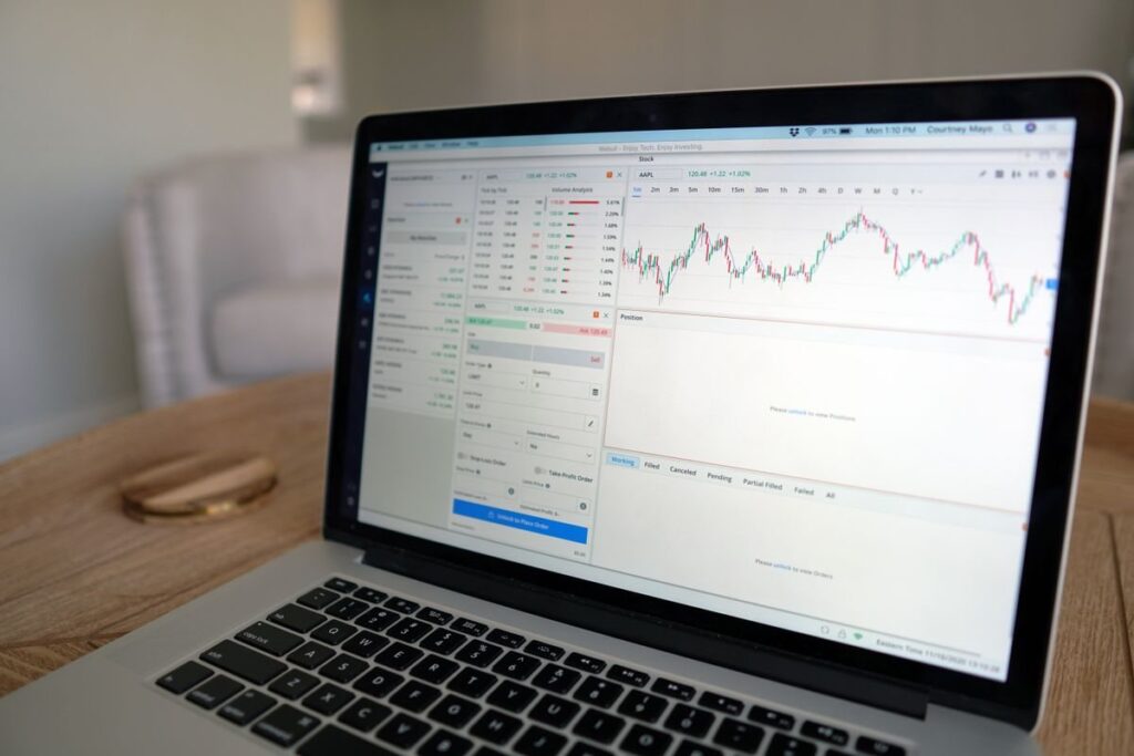 Laptop on an office desk showing a trading platform chart of the kind used to spot an ascending triangle