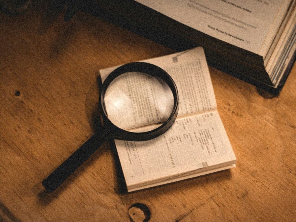 Magnifying glass over printed figures, a reminder to count pips at the correct decimal place