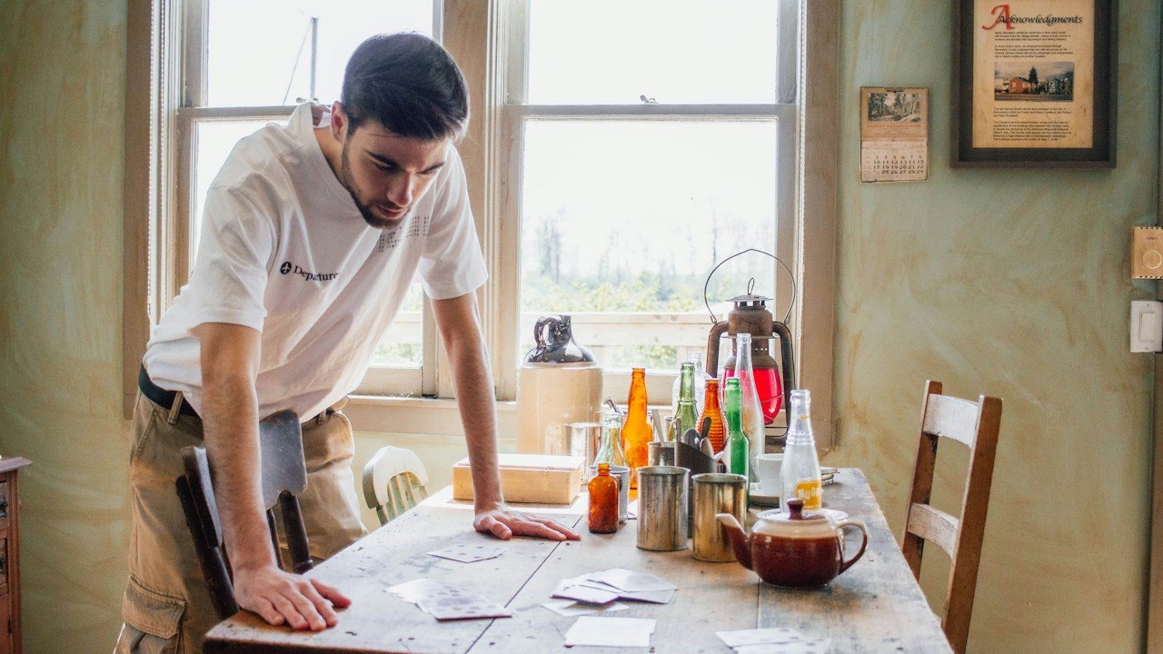 Trader studying printed charts on a table while learning market profile for beginners