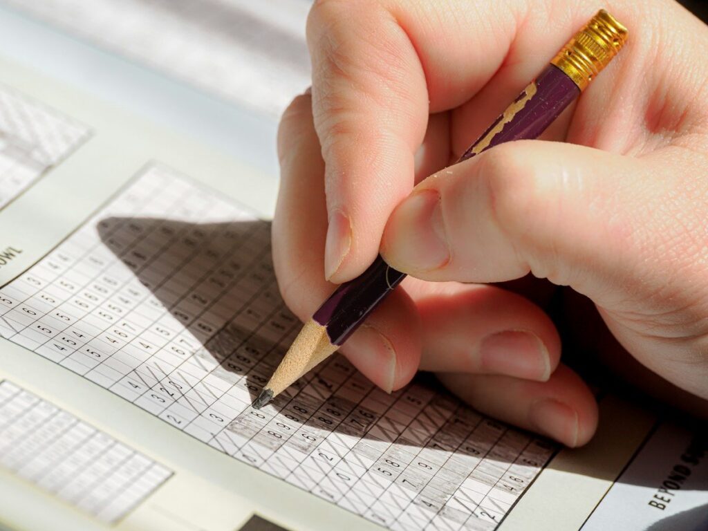 Pencil over graph paper measuring the room to the next opposing level before entering a trade