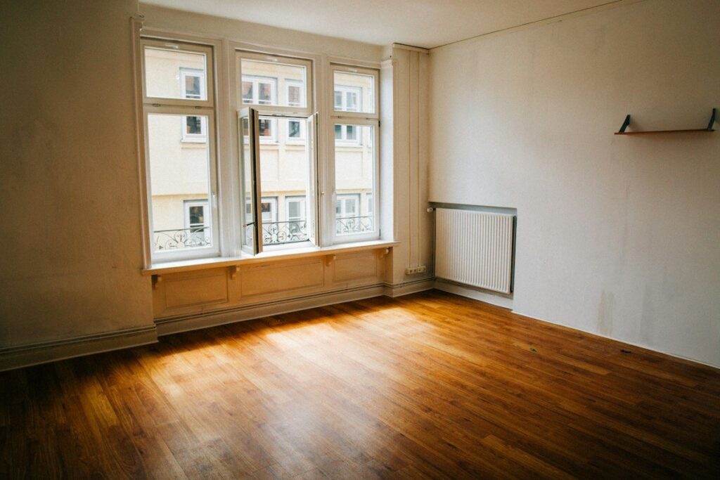 Empty room with a bare wooden floor, a picture of value migrating to a new price area