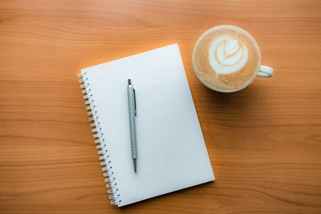 Handwritten list of personal trading triggers in a notebook, used to spot emotional trading early