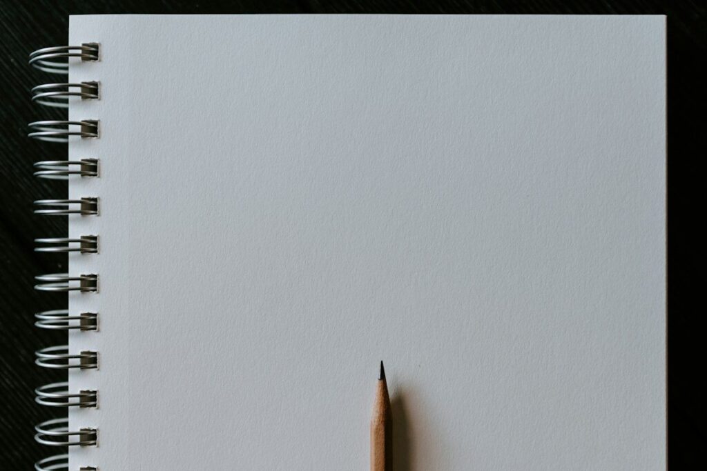 Blank notebook and pencil ready to sketch the higher highs and higher lows of a new uptrend