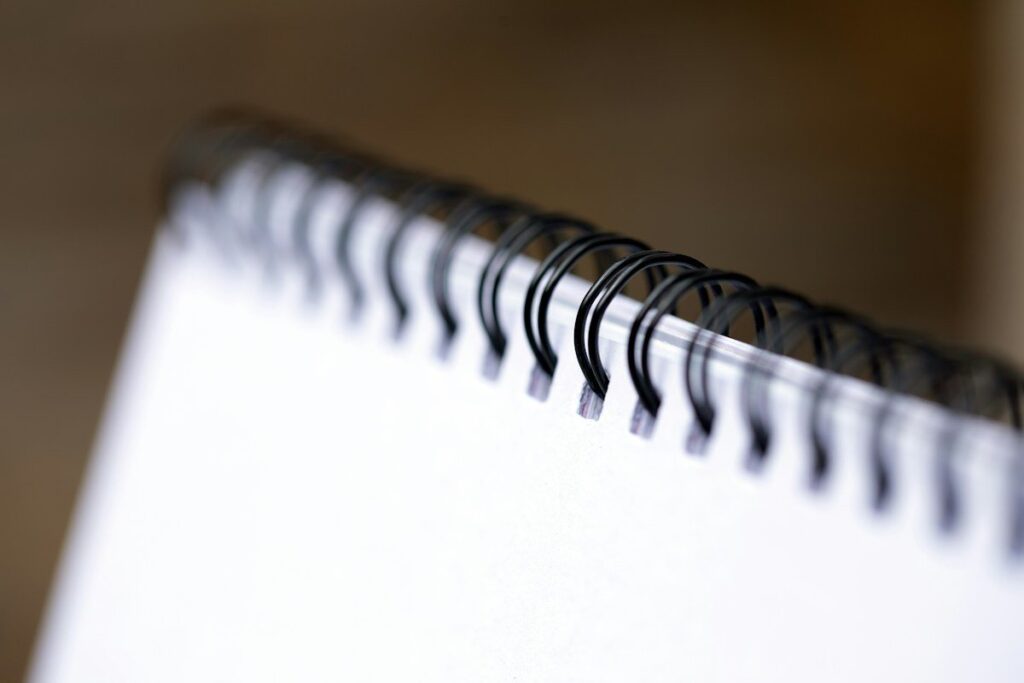 Spiral notebook close up, used to count demo trades towards a learning sample