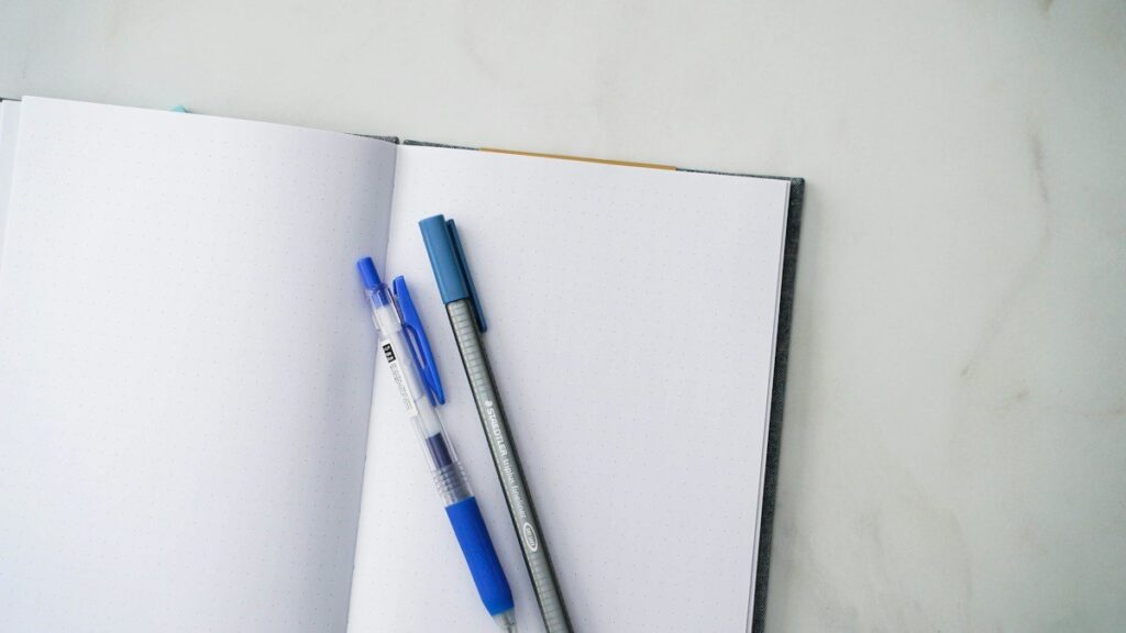 Open trading journal with highlighted entries used to track psychological patterns