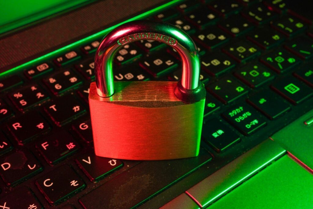Padlock resting on a closed laptop, representing the UK rules on what retail crypto traders can access