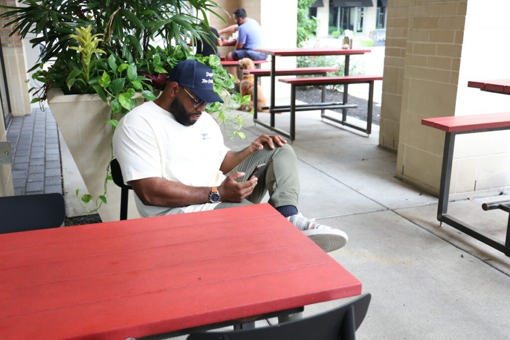 Person reading economic news on a phone before a UK or US forex data release