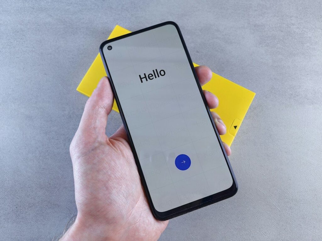Hand holding a phone with a greeting on screen; many trading course scams start with a friendly message