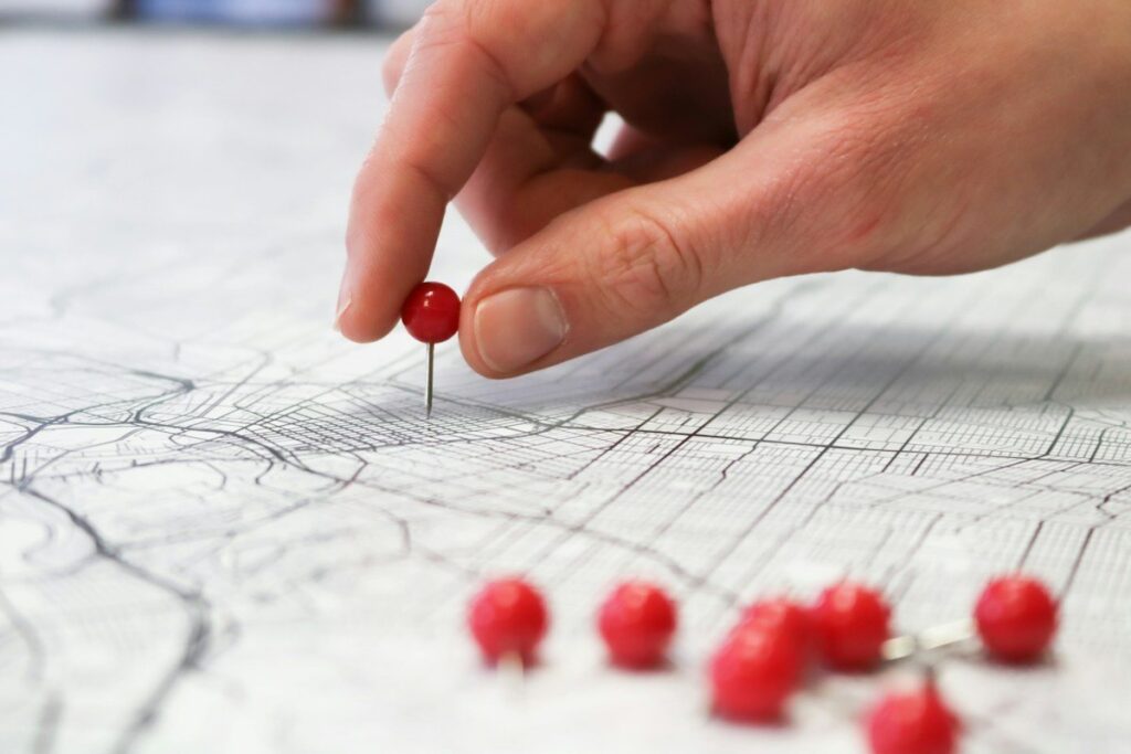 Pins marking places on a paper map, like naked POCs kept on a chart as reference levels