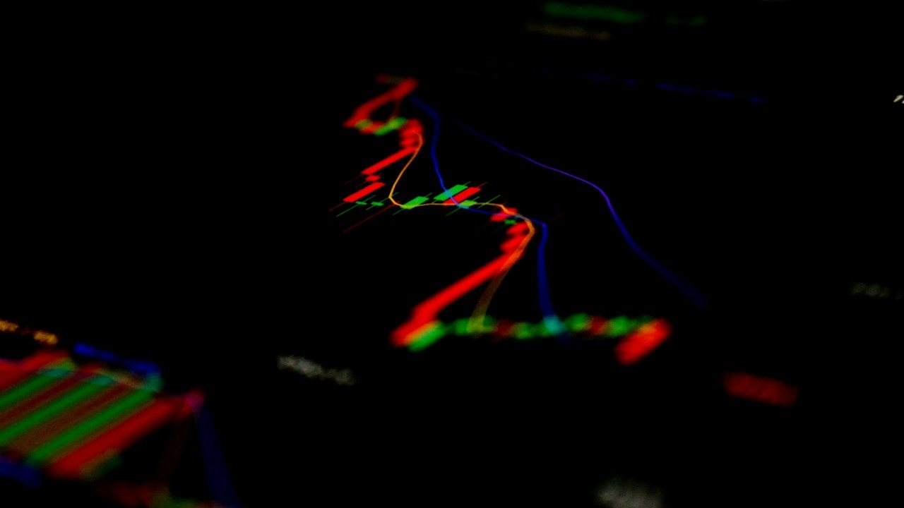 Red and green chart lines on a black screen