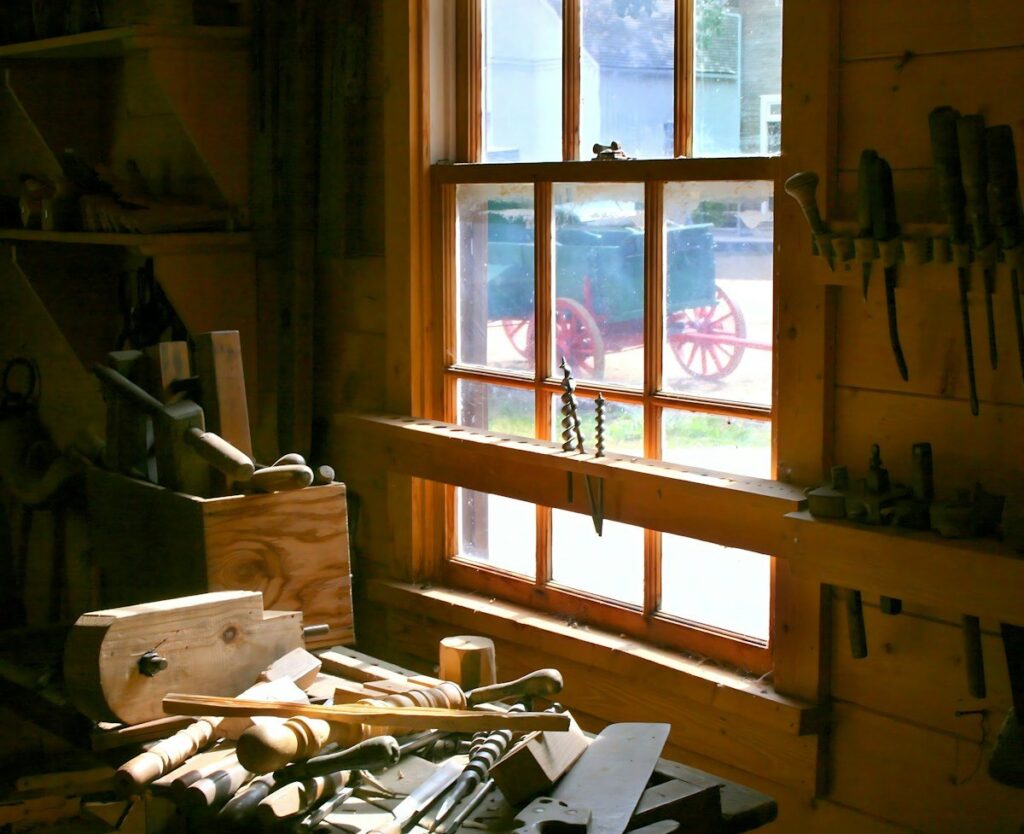 Woodworking bench with hand tools by a window, where every measurement counts, like pips and points on a chart