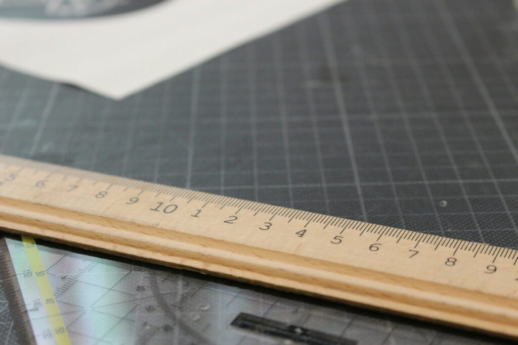 Ruler on a cutting mat, like measuring the initial balance and range extension on a profile