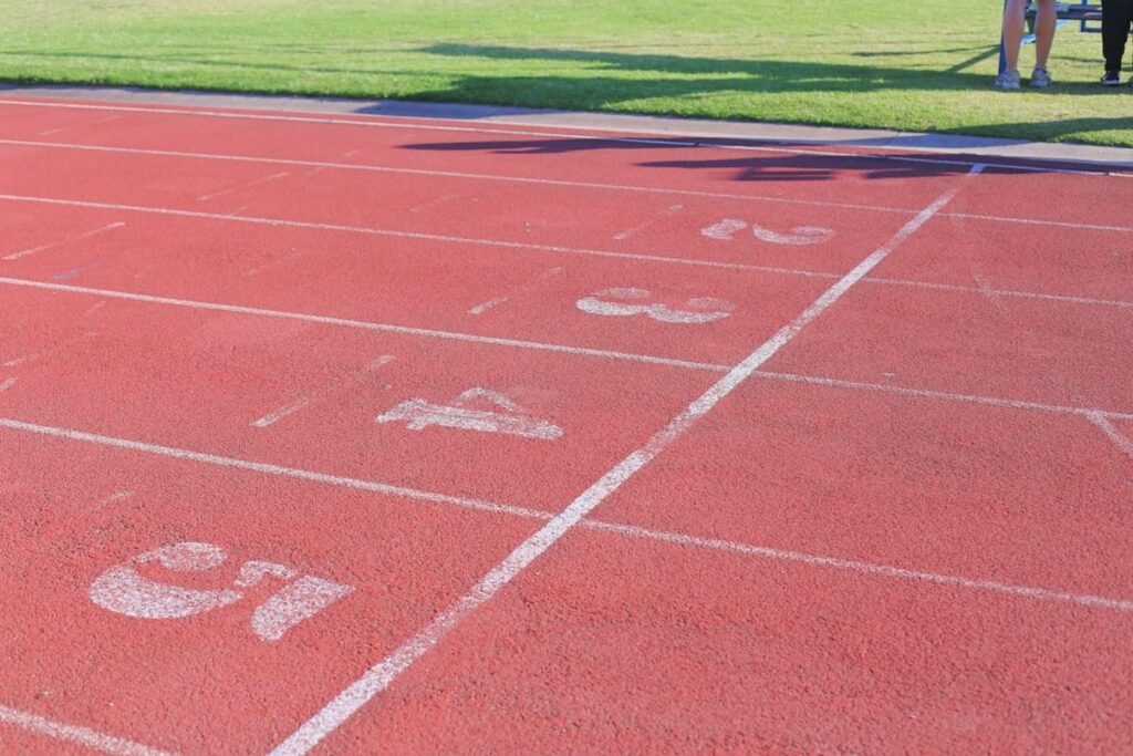 Empty running track with lane numbers at the start, like a stop entry order waiting for price to break a level
