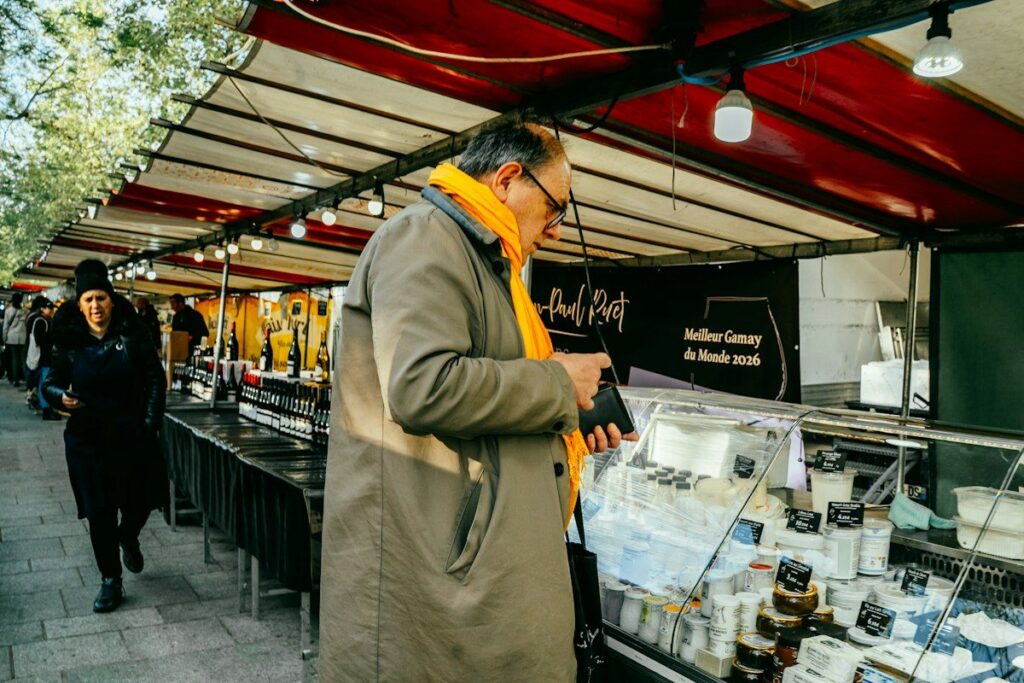 Shopper checking price tags at a market stall, like a limit order that only fills at a set price