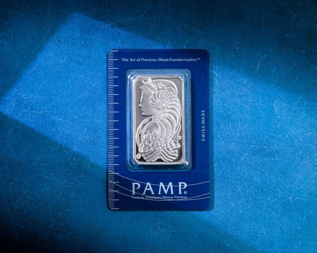 Silver bar in a sealed pack on a blue surface