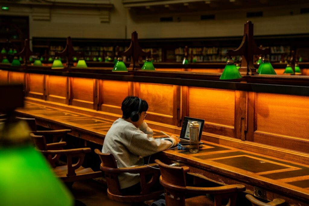 Woman typing journal columns into a spreadsheet on a laptop, setting up a simple trade log