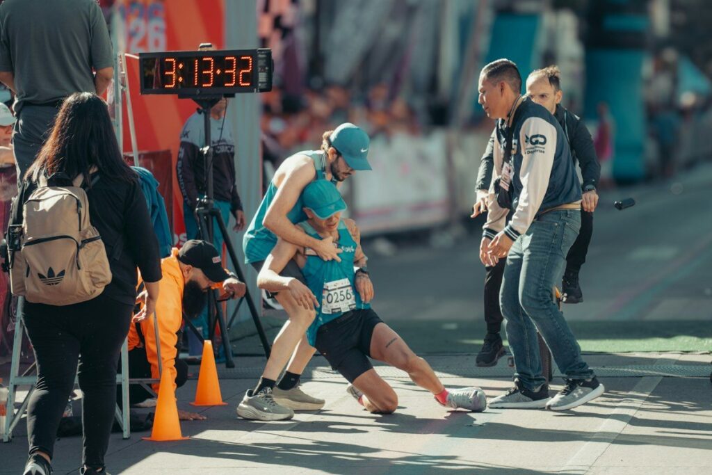 Runners at the finish of a race beside a clock, the burst of movement a flag breakout trigger waits for