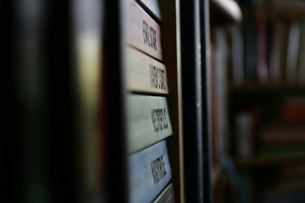 Row of labelled folders on a shelf, showing a trading journal habit kept up over months