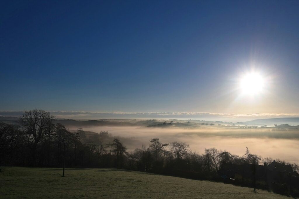 Sunrise over a misty valley, a picture of a downtrend ending in an inverse head and shoulders