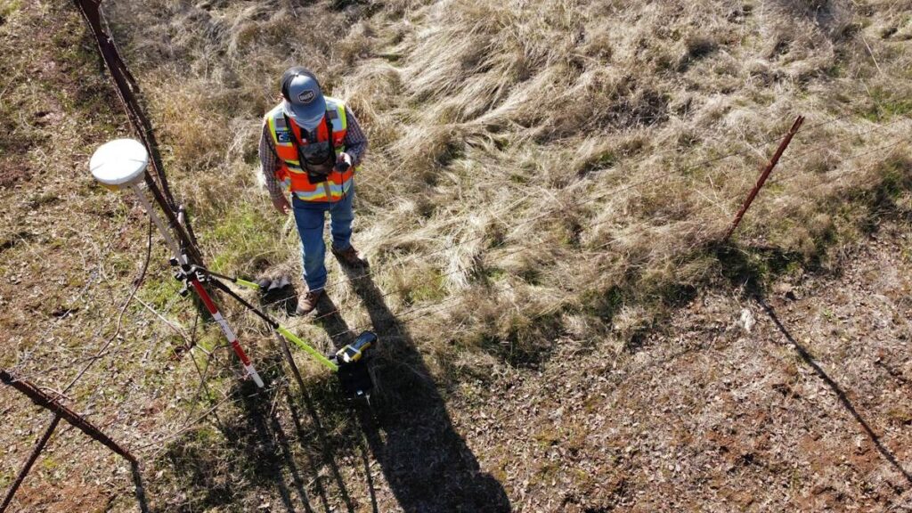 Surveyor measuring heights in a field, like marking the six types of key level on a chart