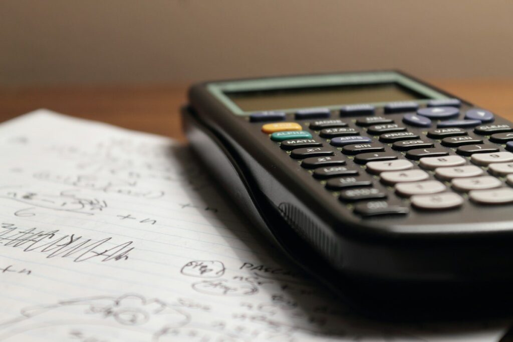Calculator resting on a page of handwritten notes