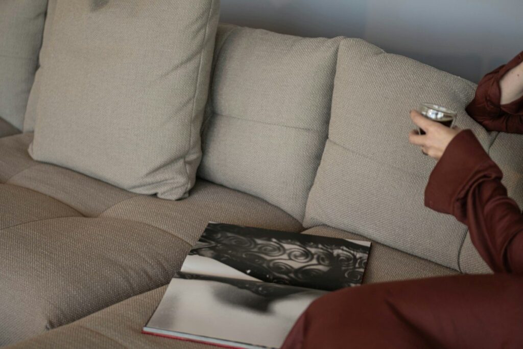 Person holding a book on a sofa, checking how a hypothetical spread bet would work