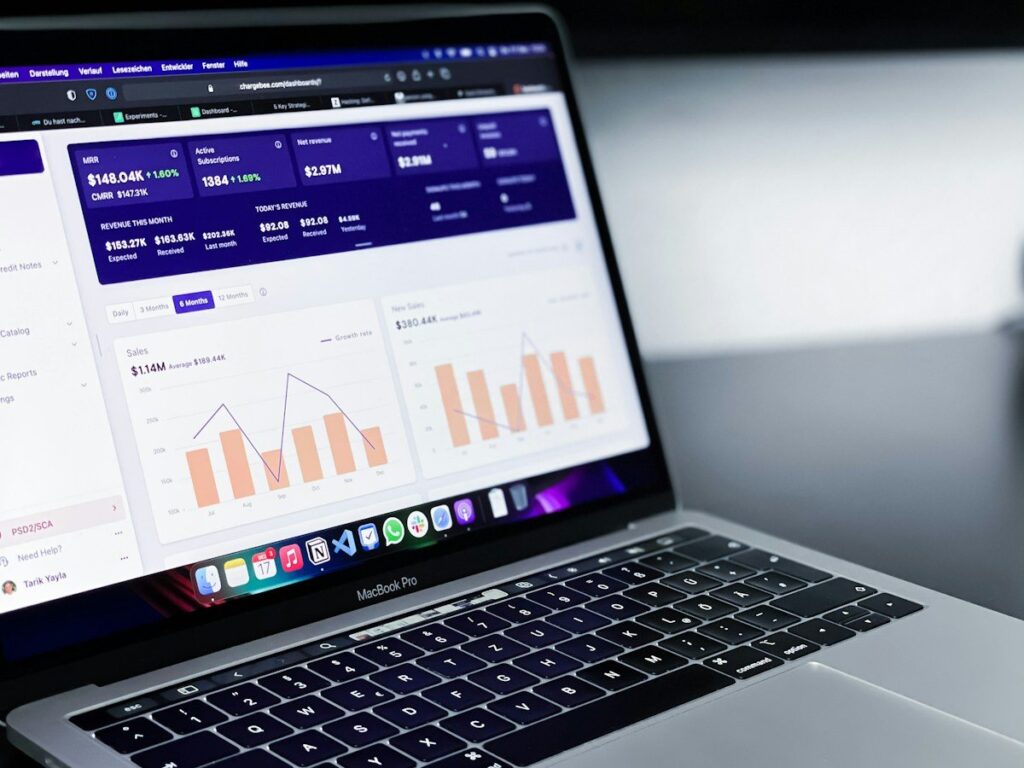 Laptop showing a dashboard of figures and bar charts