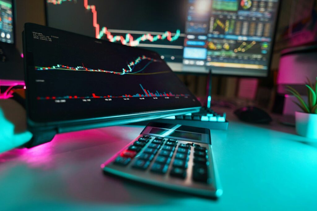 Forex trader comparing currency charts on two monitors