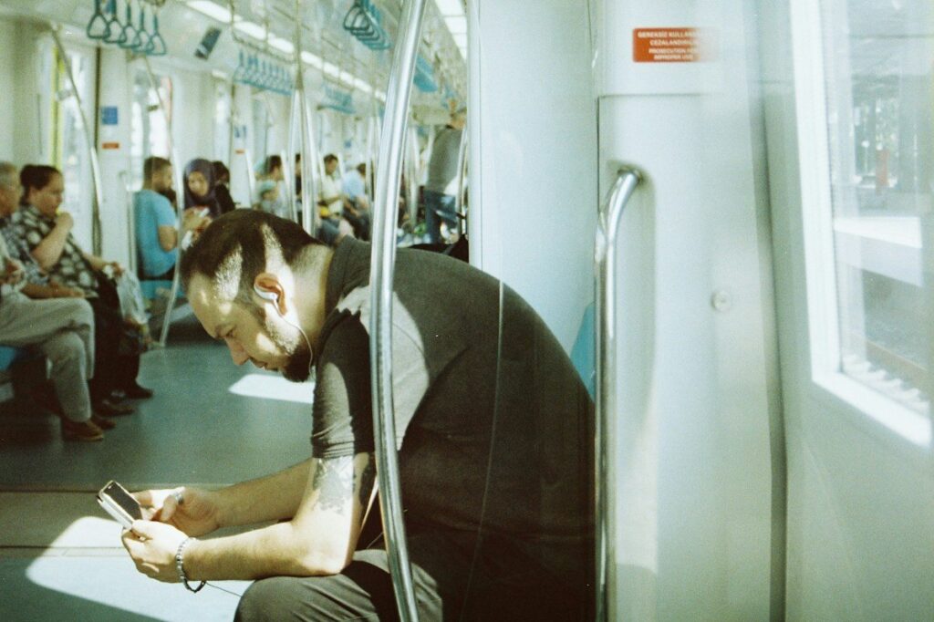 Man on a train looking at his phone